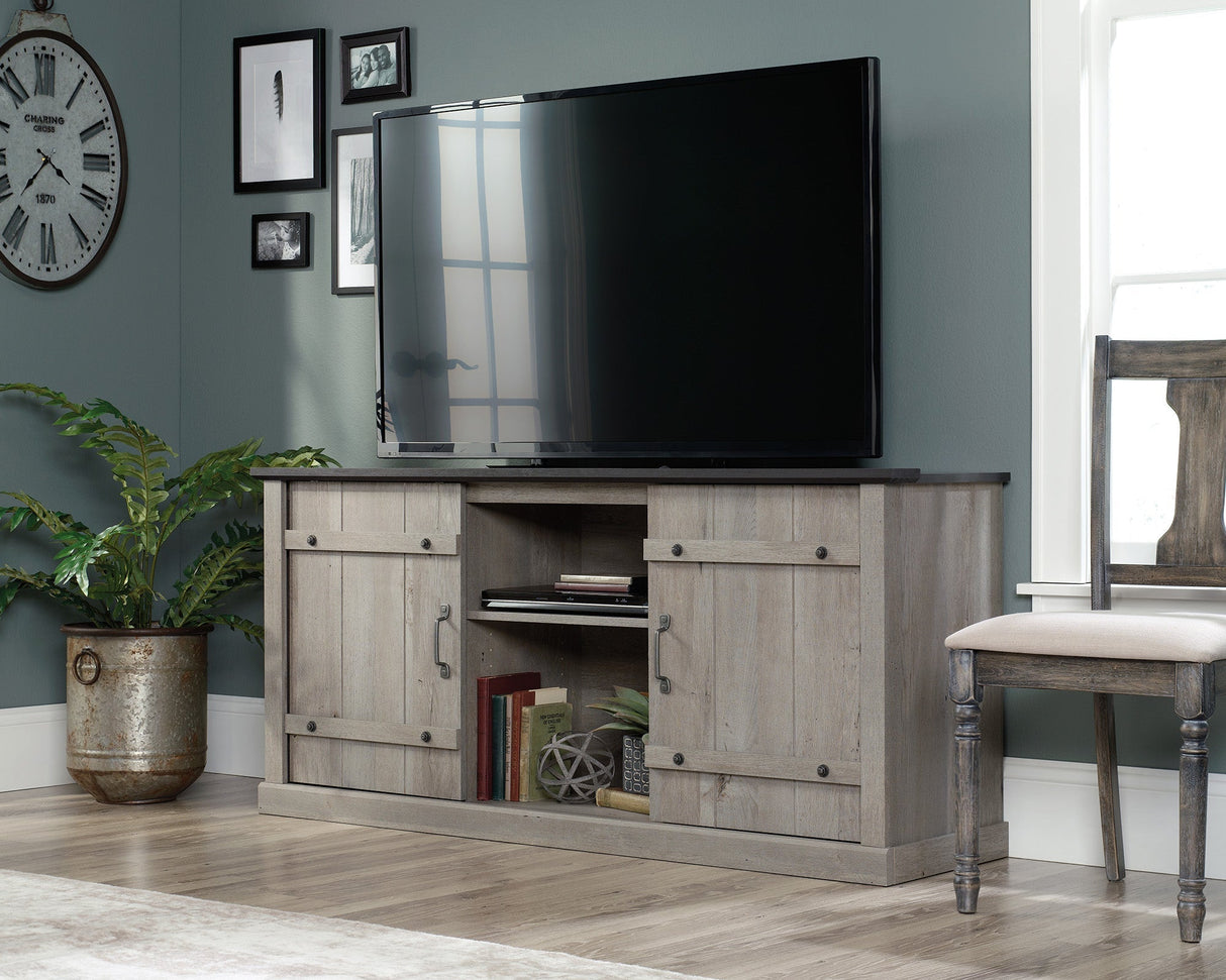 Modern farmhouse TV stand in Mystic Oak with sliding barn doors and storage shelves